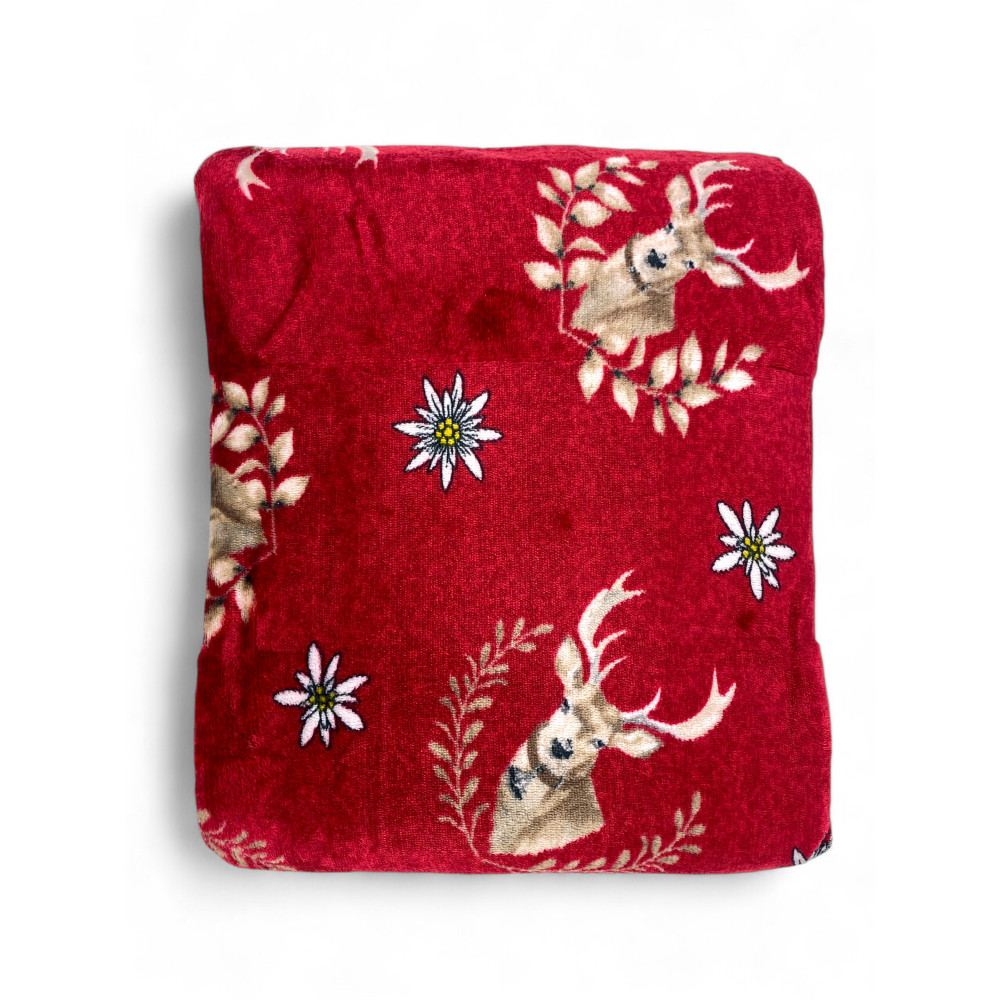 Folded Sherpa blanket with deer motif and visible lambskin side