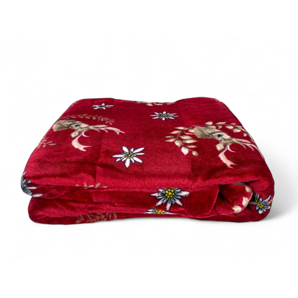 Red Deer plaid on armchair with snowy window, winter atmosphere